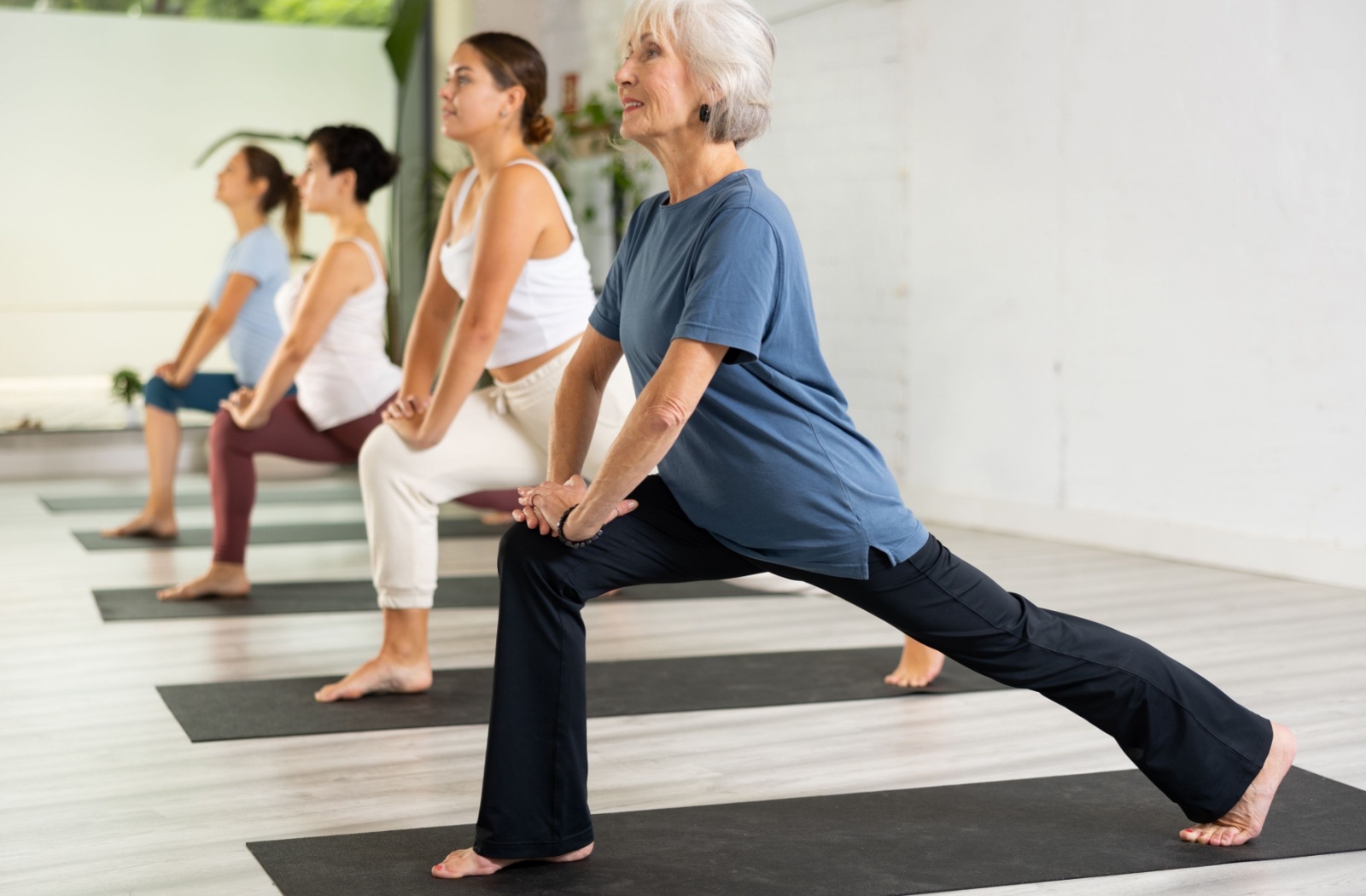 A senior participates in a yoga class to ease their arthritis pain.