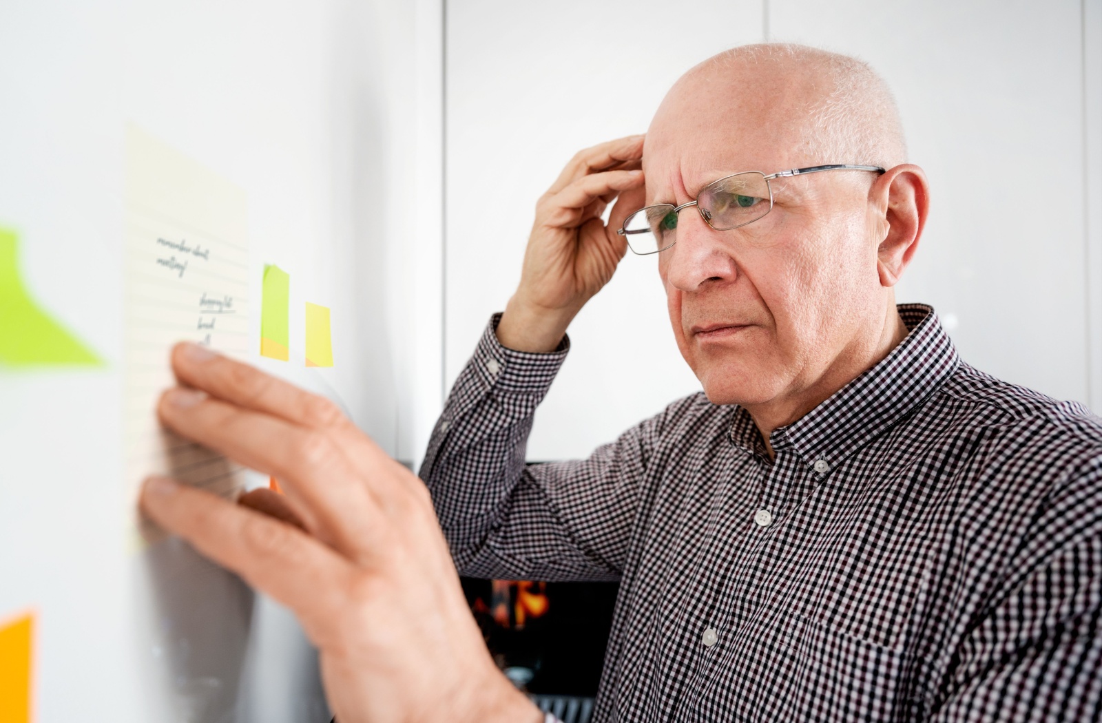 A confused senior checks notes to remember what the schedule is for the day.